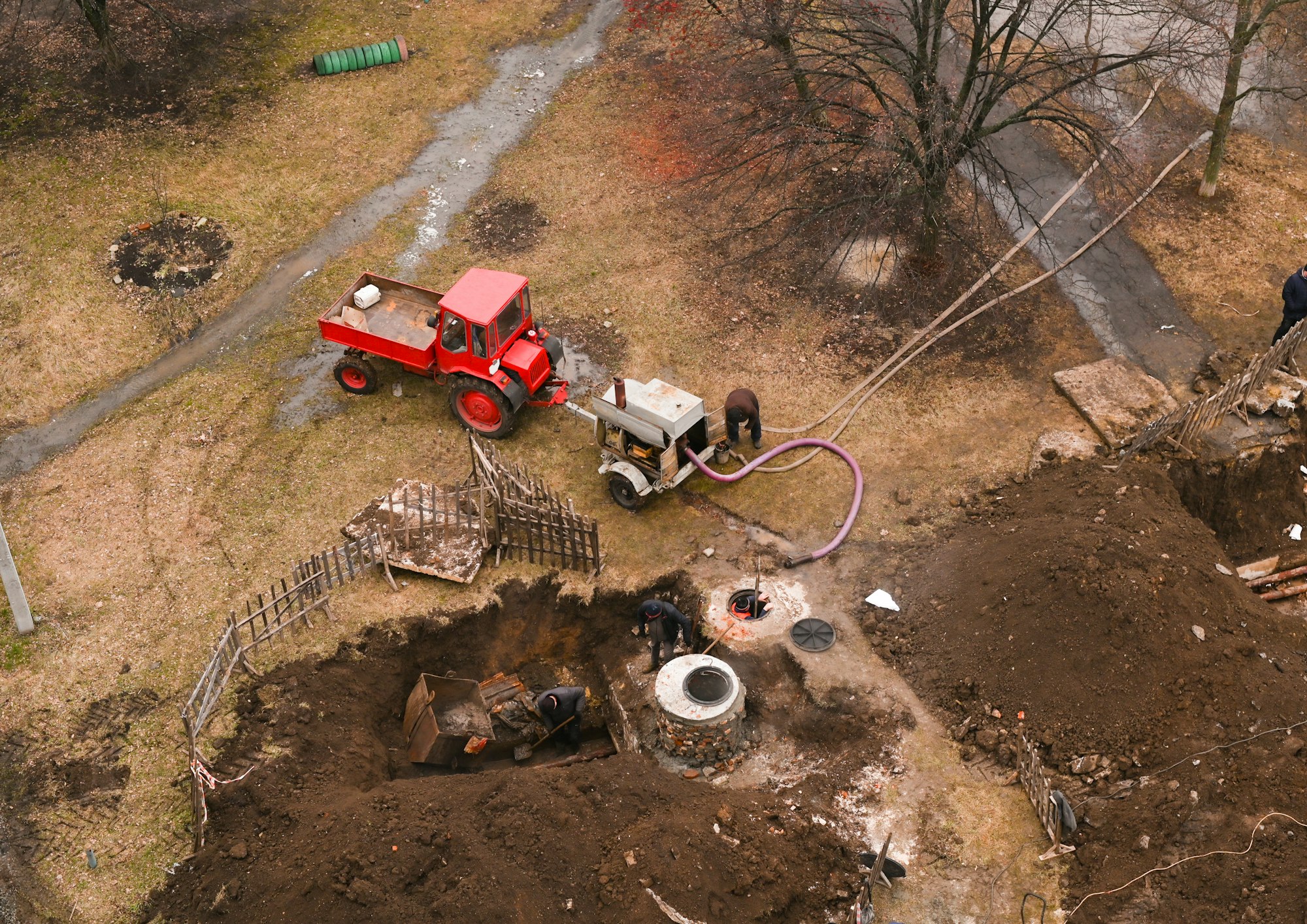 pumping water from a sewer well. the tractor attracted a large industrial compressor.